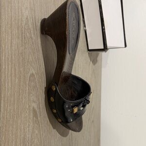 Tod's Black patent Leather Mules with Gold Accents